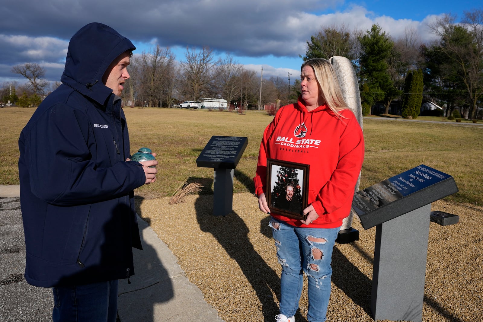 Eric Pranger and Shannon Doughty talk by a memorial, Saturday, Dec. 21, 2024, in Westfield, Ind. (AP Photo/Darron Cummings)