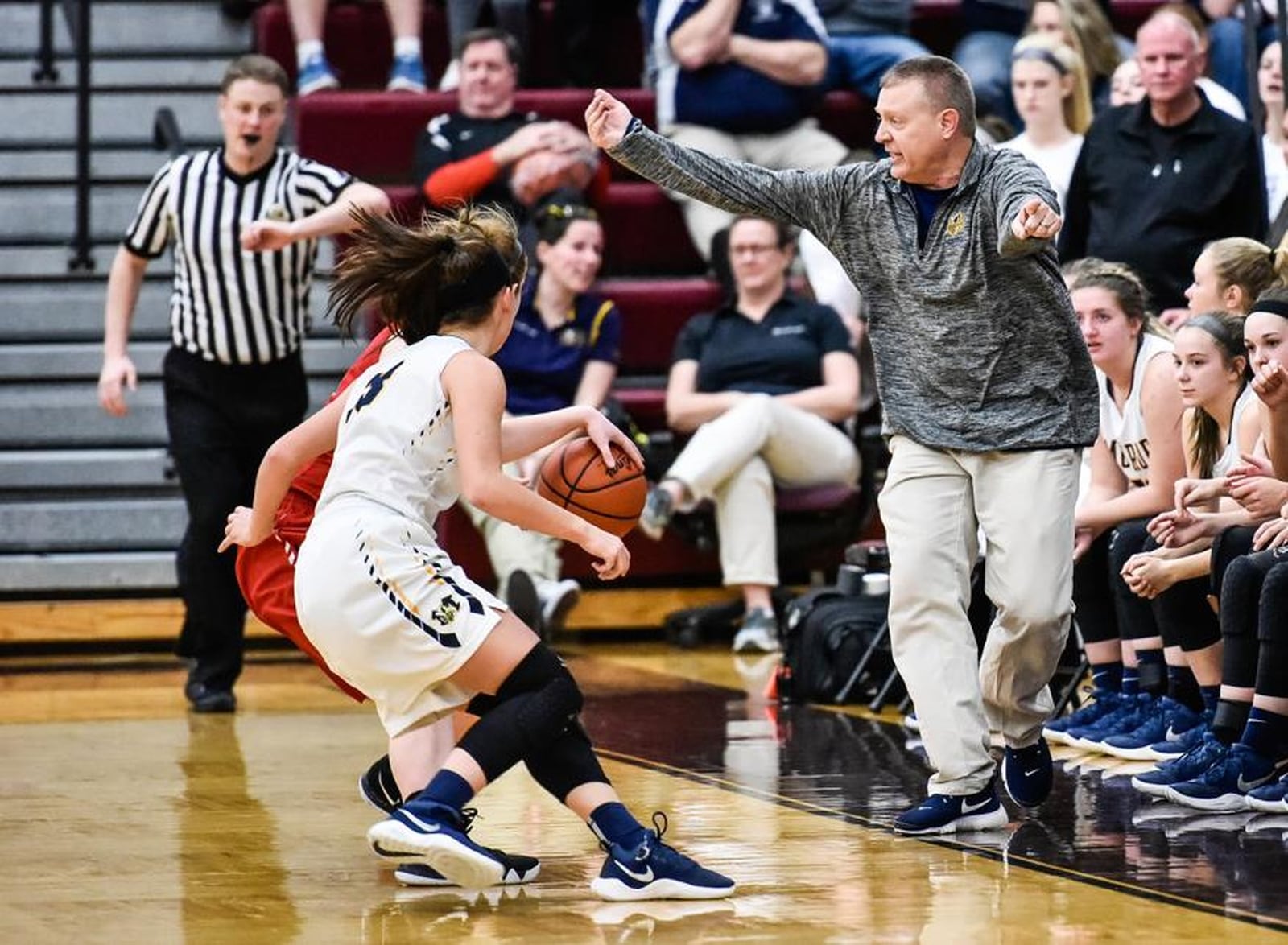 Monroe coach Chad Allen works the sideline as play continues in front of him during Monday night’s Division II sectional final against Franklin at Lebanon. NICK GRAHAM/STAFF