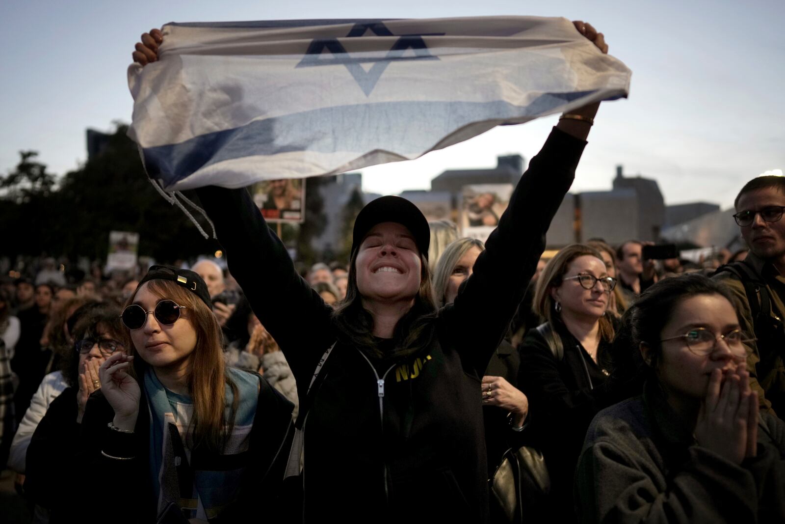 Relatives and friends of people killed and abducted by Hamas and taken into Gaza, react as they gather in Tel Aviv, Israel on Sunday, Jan. 19, 2025. (AP Photo/Oded Balilty)