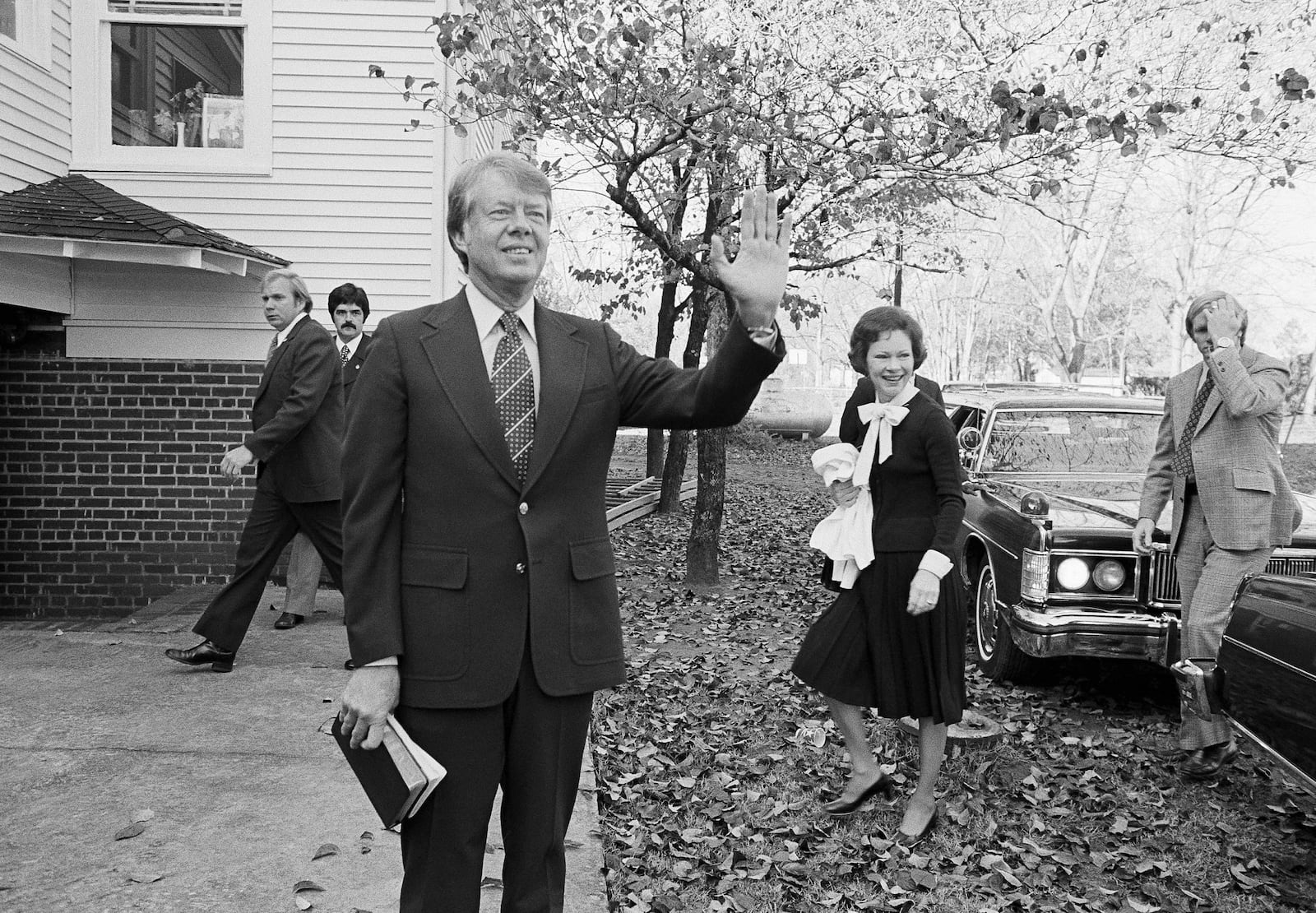 FILE - Then President-elect Jimmy Carter waves to the crowd as he and his wife Rosalynn arrive at the Plains Baptist Church to attend services in Plains, Ga., on Nov. 22, 1976. (AP Photo, File)