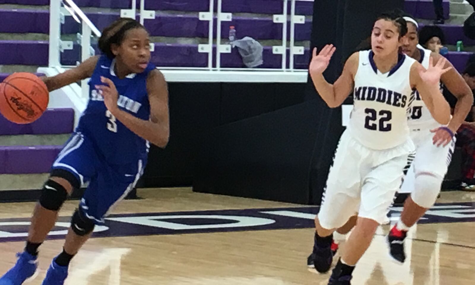 Hamilton’s Anna Cardwell (3) drives past Arianna Layne of Middletown on Saturday afternoon at Wade E. Miller Arena in Middletown. RICK CASSANO/STAFF