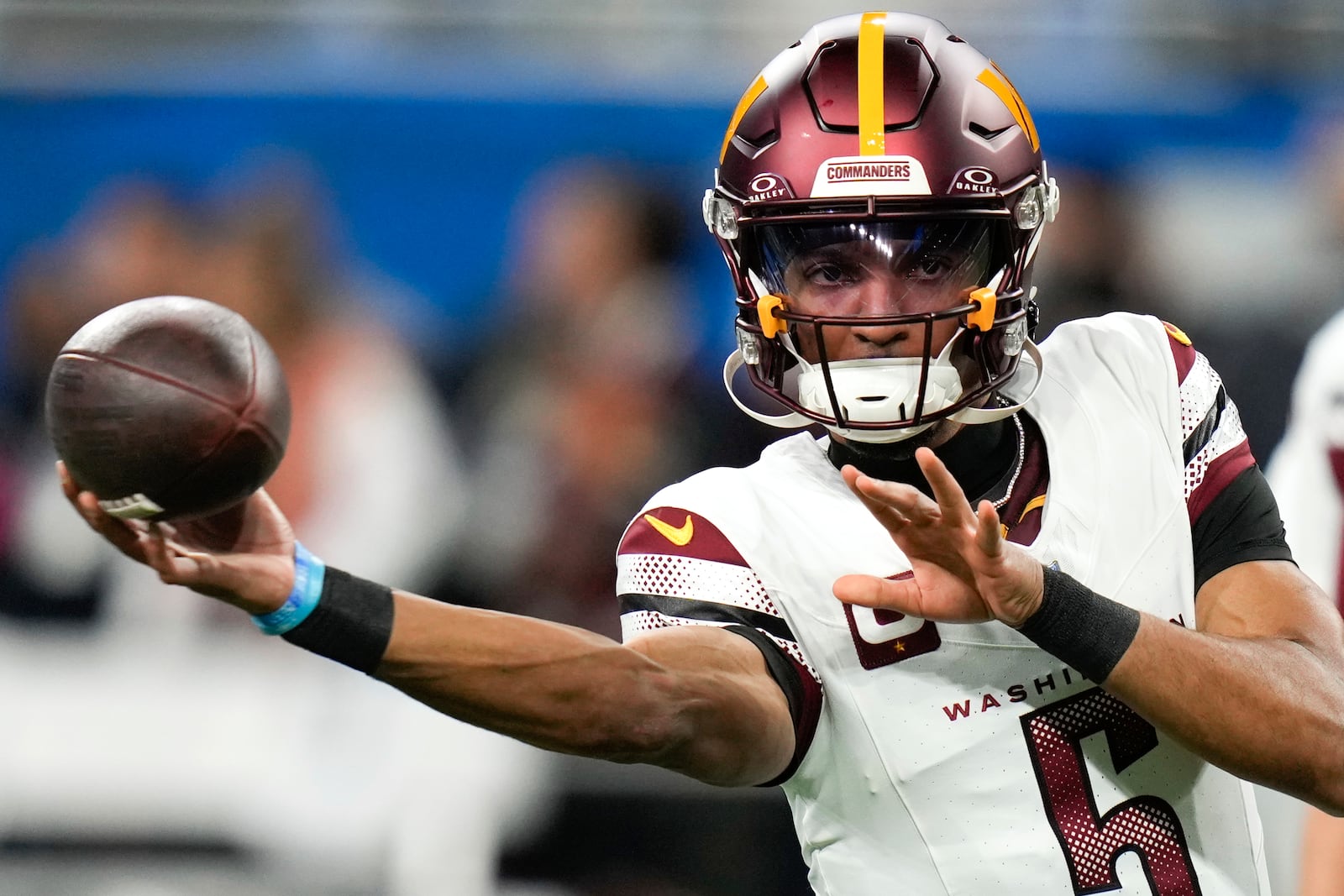 Washington Commanders quarterback Jayden Daniels throws during warmups before an NFL football divisional playoff game, Saturday, Jan. 18, 2025, in Detroit. (AP Photo/Seth Wenig)