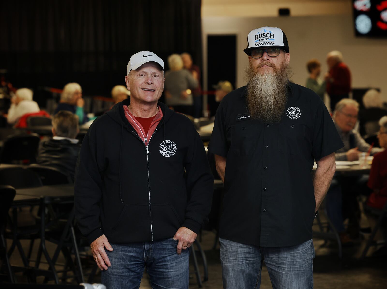 Pohlman Lanes owner Jeff Pohlman, left, and general manager Joe Hoelle stand near the stage area Wednesday,  Jan. 12, 2022. Pohlman Lanes has turned some of their bowling lanes into multi-use space with a stage, tables and room for dancing and other activities. NICK GRAHAM / STAFF