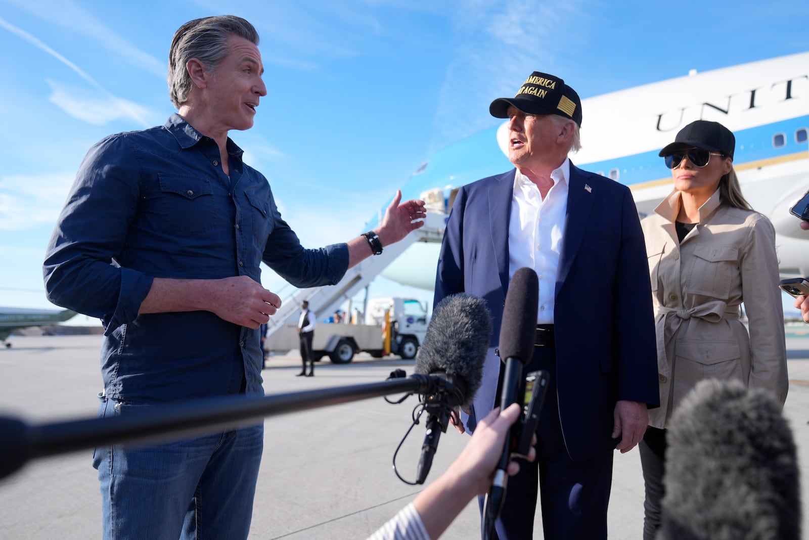 President Donald Trump and first lady Melania Trump listen to California Gov. Gavin Newsom after arriving on Air Force One at Los Angeles International Airport in Los Angeles, Friday, Jan. 24, 2025. (AP Photo/Mark Schiefelbein)