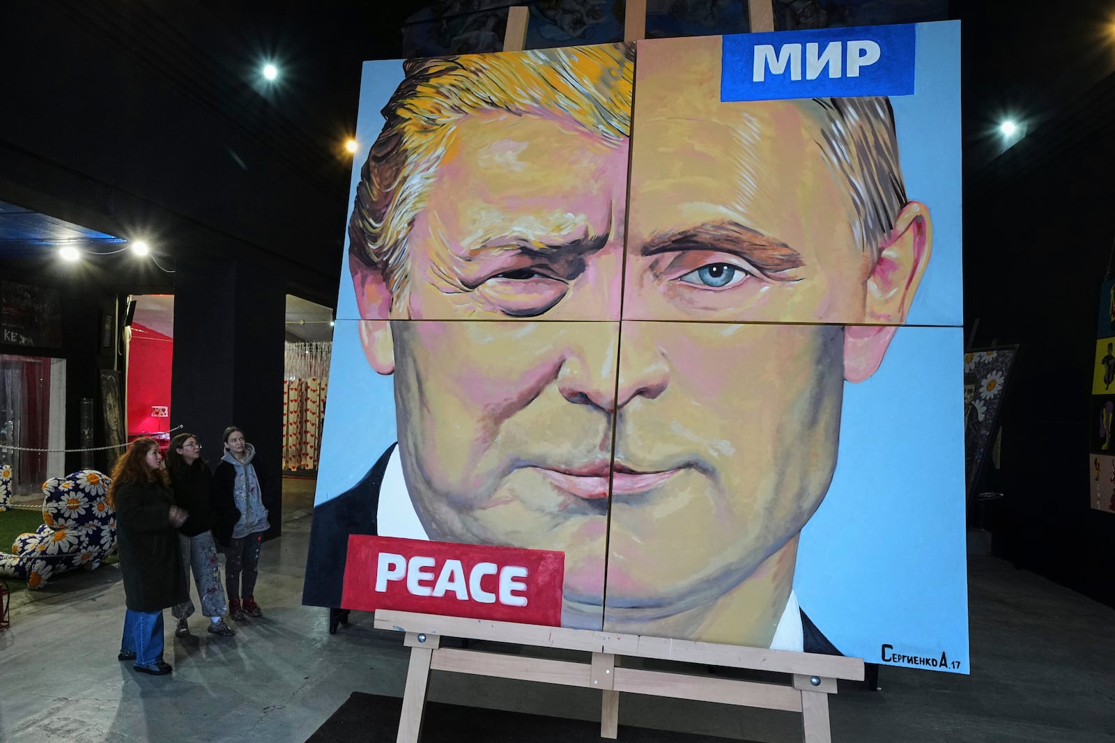 "Peace to the world", a painting created by Russian artist Alexei Sergienko showing a combination of faces of Russian President Vladimir Putin and US President Donald Trump, is on display at the Sergienko's gallery in St. Petersburg, Russia, Friday, March 14, 2025. (AP Photo/Dmitri Lovetsky)