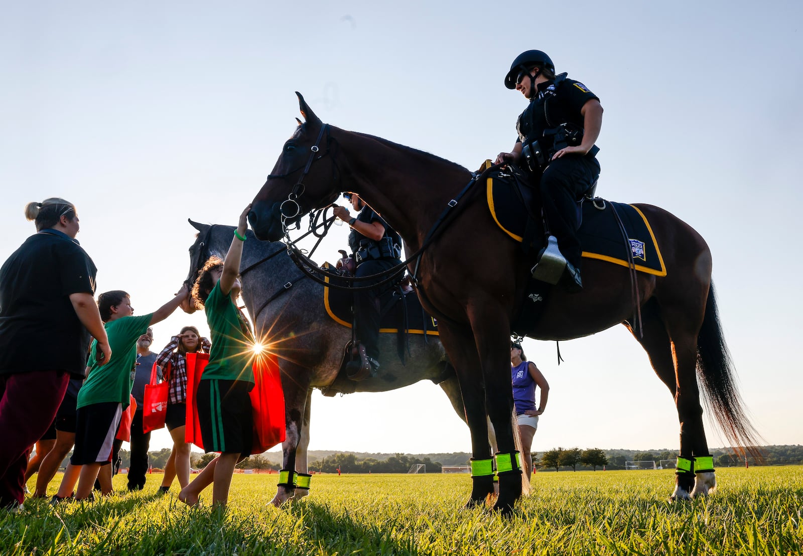 Middletown police officers Jessica Payne, left, on her horse, Luka, and Lindsey Schwarber, on her horse, Dewey, were walking around during the Middletown Division of Police National Night Out event Tuesday, Aug. 2, 2022 at Smith Park. There were police k-9 and swat demonstrations, CareFlight helicopter, dunking booth, free food from Gold Star Chili and Kona Ice, bouncy houses, vendors and more. NICK GRAHAM/STAFF