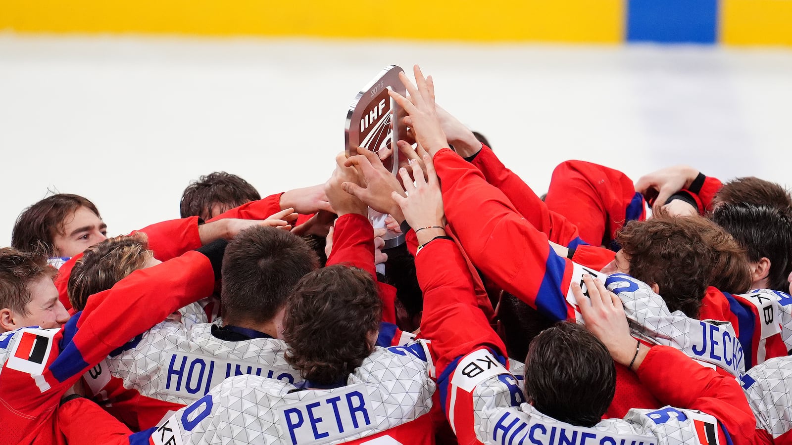 Czechia players touch the trophy after they defeated Sweden to take the World Junior Hockey Championship bronze medal in Ottawa, Ontario, Sunday, Jan. 5, 2025. (Sean Kilpatrick/The Canadian Press via AP)