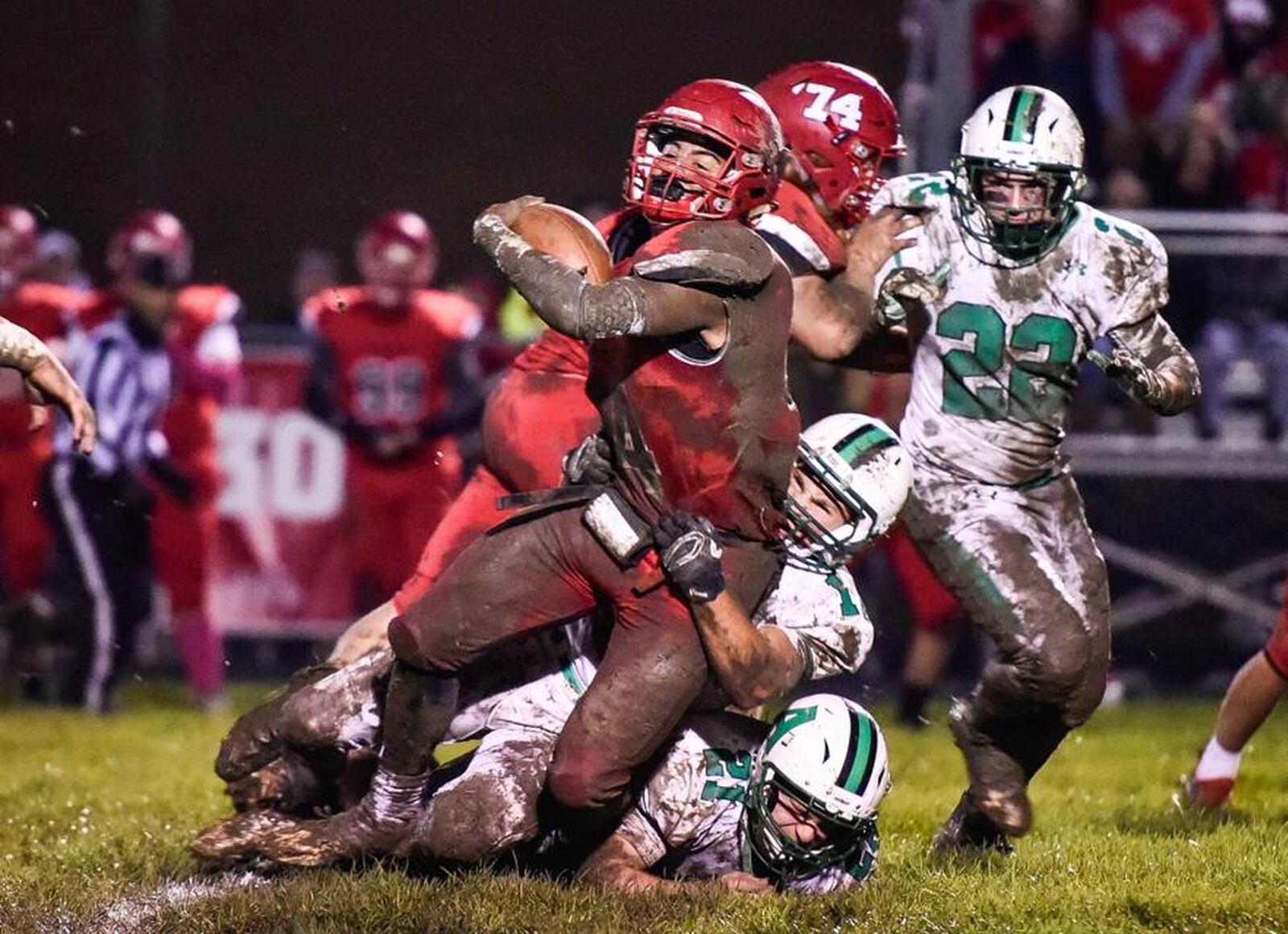 Madison halfback Evan Crim (34) fights for extra yardage during last Friday night’s 14-10 win over visiting Anna in a Division V, Region 20 quarterfinal at Brandenburg Field in Madison Township. NICK GRAHAM/STAFF