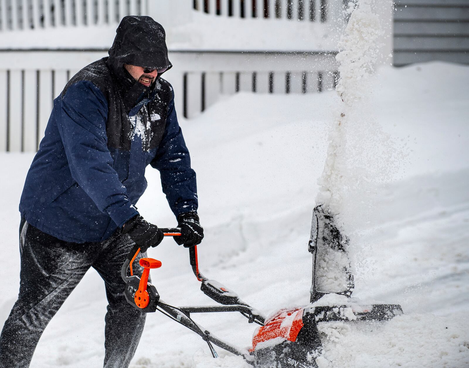 Chris Crowley struggles with heavy, wet snow Sunday afternoon, Feb. 16, 2025, as wind and driving sleet made conditions difficult to remove snow from a driveway on Shawmut Street in Lewiston, Maine. (Russ Dillingham/Sun Journal via AP)