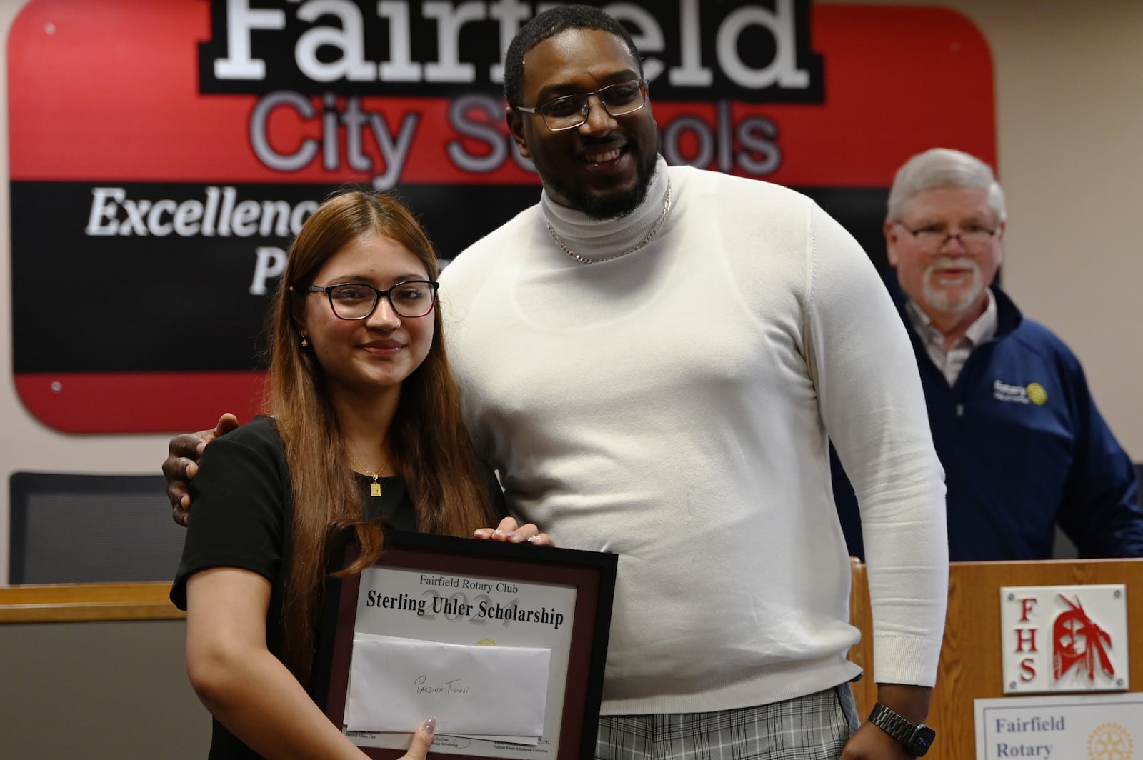 Parsina Tiwari, left, was named the Sterling Uhler Scholarship winner by the Fairfield Rotary Club on Thursday, May 16, 2024. Tiwari, who posed for a picture with Rotary President Anthony Neal, plans to study nursing at Miami University. MICHAEL D. PITMAN/STAFF