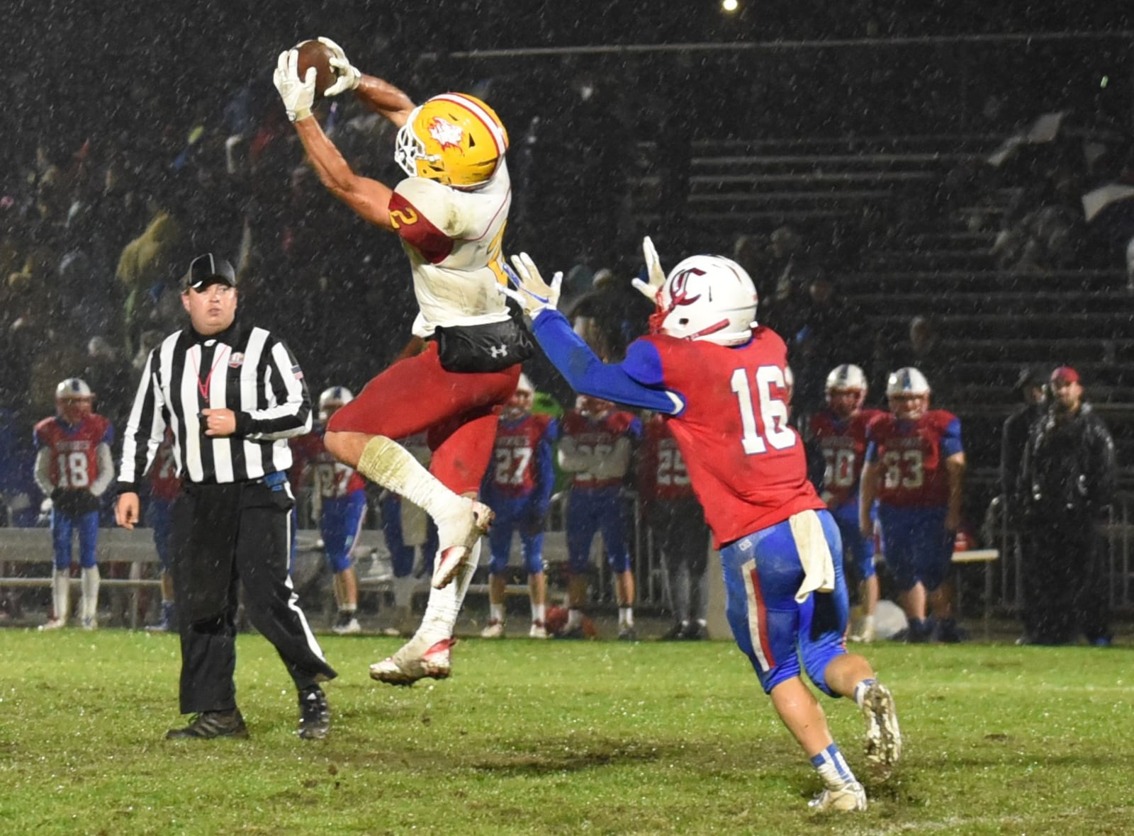 Fenwick’s R.J. Clesceri (2) jumps for a catch in front of Carroll’s Ethan Braun on Friday night in Riverside. The visiting Falcons won 42-41. CONTRIBUTED PHOTO BY ANGIE MOHRHAUS