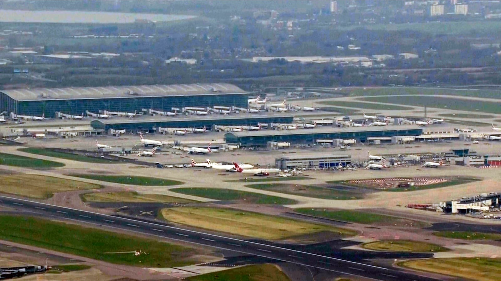 This image taken from video shows parked planes at Heathrow airport, as a fire at the North Hyde electrical substation on Thursday night has led to a closure of Heathrow Airport in London, Friday, March 21, 2025. (Sky News via AP)