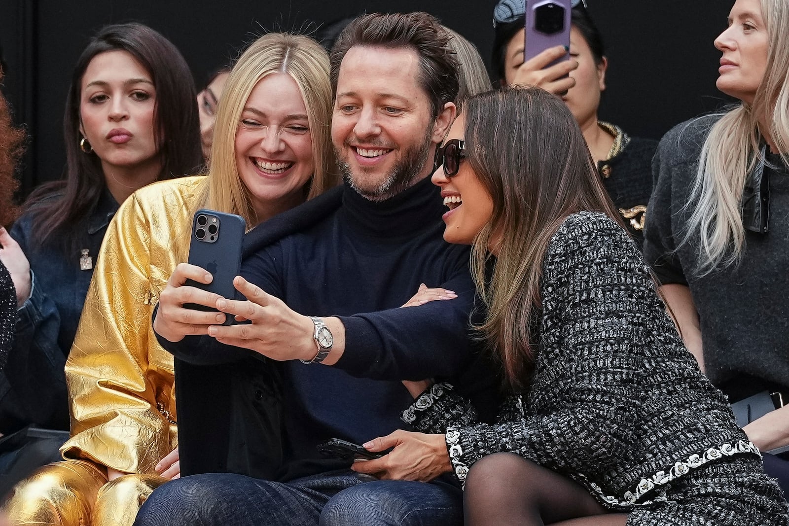 Dakota Fanning, from left, Derek Blasberg, and Jessica Alba attend the Chanel Fall/Winter 2025-2026 Womenswear collection presented Tuesday, March 11, 2025. in Paris. (Photo by Scott A Garfitt/Invision/AP)