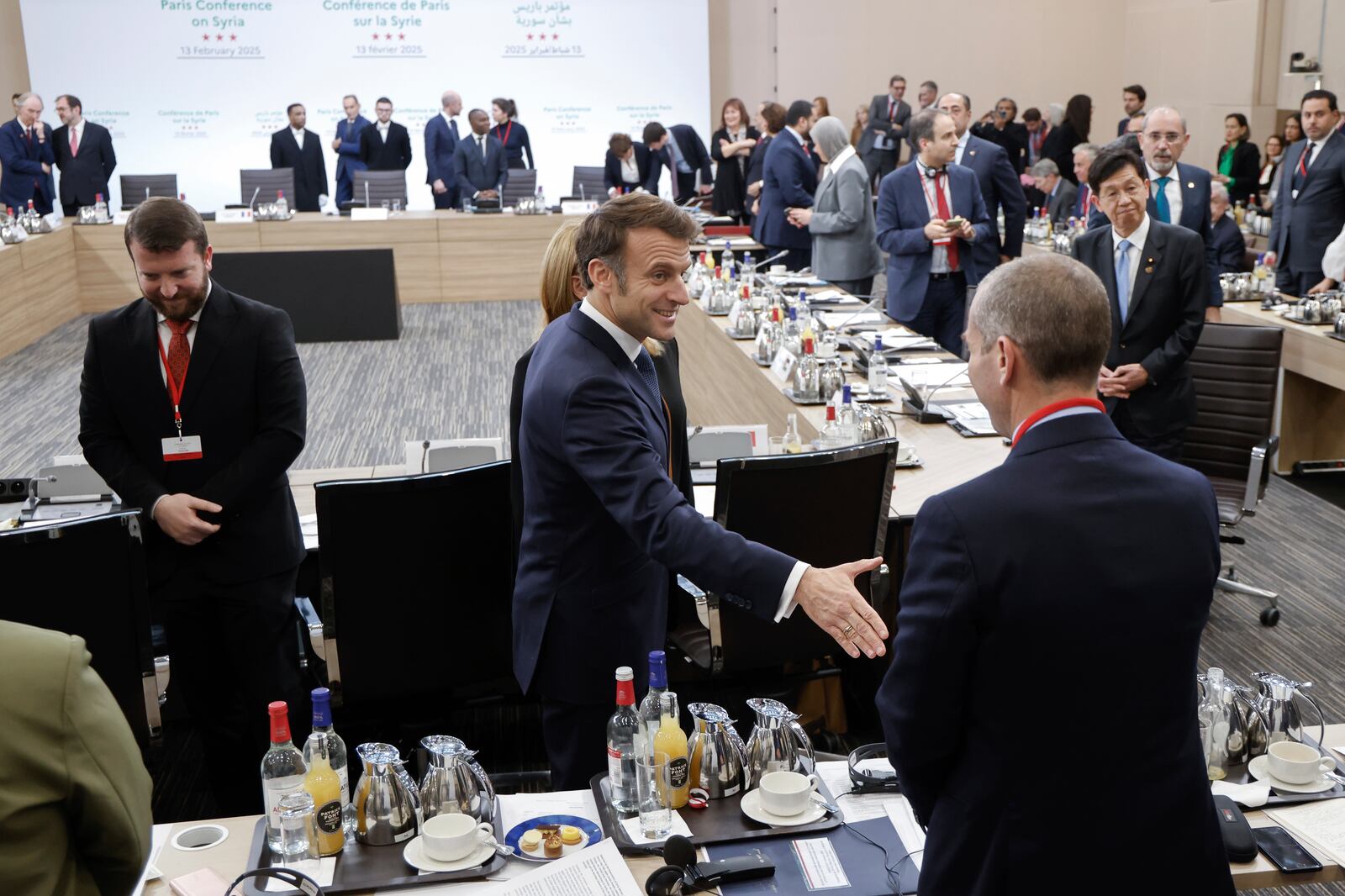 France's President Emmanuel Macron greets participants as he arrives at the International Conference on Syria at the Ministerial Conference Center, in Paris, France, Thursday, Feb. 13, 2025. (Ludovic Marin, Pool Photo via AP)