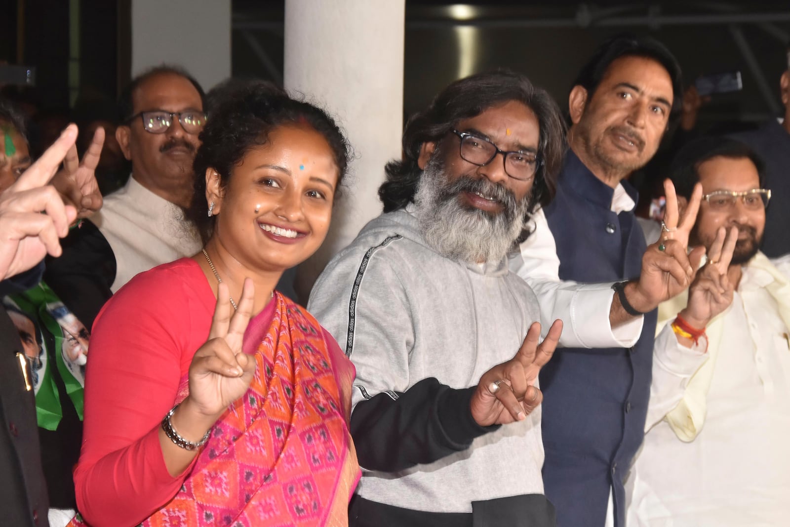 Jharkhand Chief Minister Hemant Soren, center, with his wife Kalpana Soren, left, show victory sign after their party won state election, in Ranchi, in the Indian state of Jharkhand, Saturday, Nov. 23, 2024. (AP Photo/Rajesh Kumar)