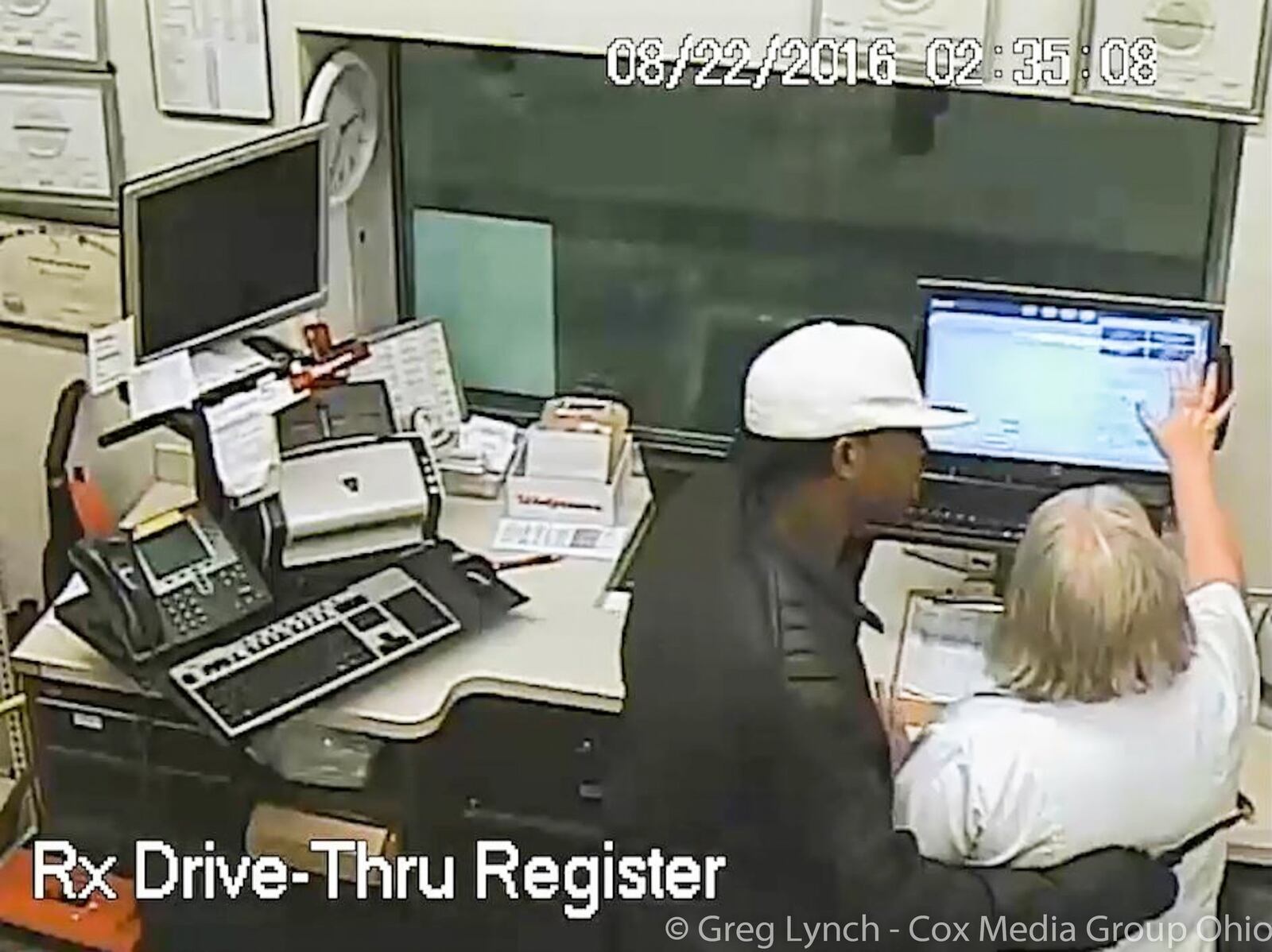 A still clip from video of the officer-involved shooting at Walgreens in Hamilton shows the suspect, Kelley Brandon Forte, pulling out a knife inside the Walgreens at 1090 High St. on Aug. 22. and asking the pharmacist for drugs and money. HAMILTON POLICE DEPARTMENT / CONTRIBUTED