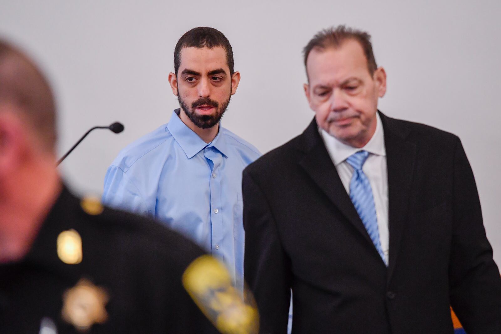 Hadi Matar, left, charged with severely injuring author Salman Rushdie in a 2022 knife attack, is led into Chautauqua County court by public defender Nathaniel Barone before the start of jury selection in Mayville, N.Y., Tuesday, Feb. 4, 2025. (AP Photo/Adrian Kraus)