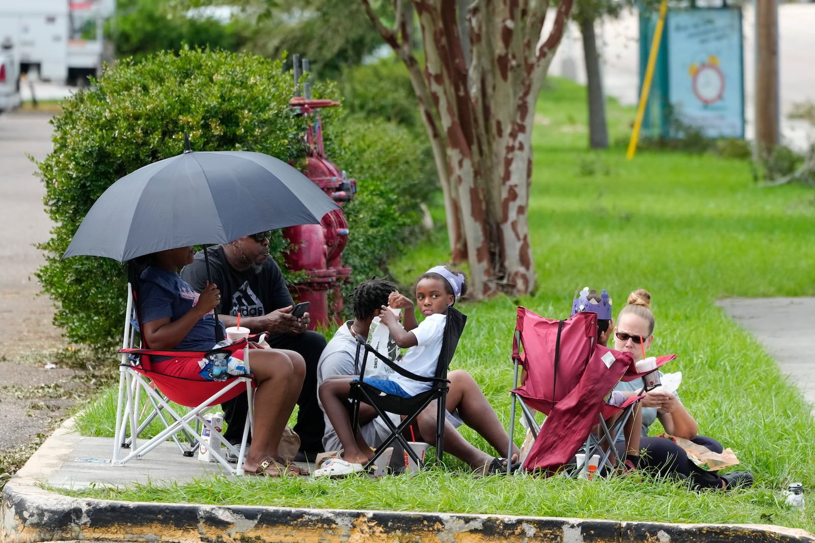 Residents wait to get access back into the apartment complex which was flooded by Hurricane Milton, Friday, Oct. 11, 2024, in Clearwater, Fla. (AP Photo/Julio Cortez)