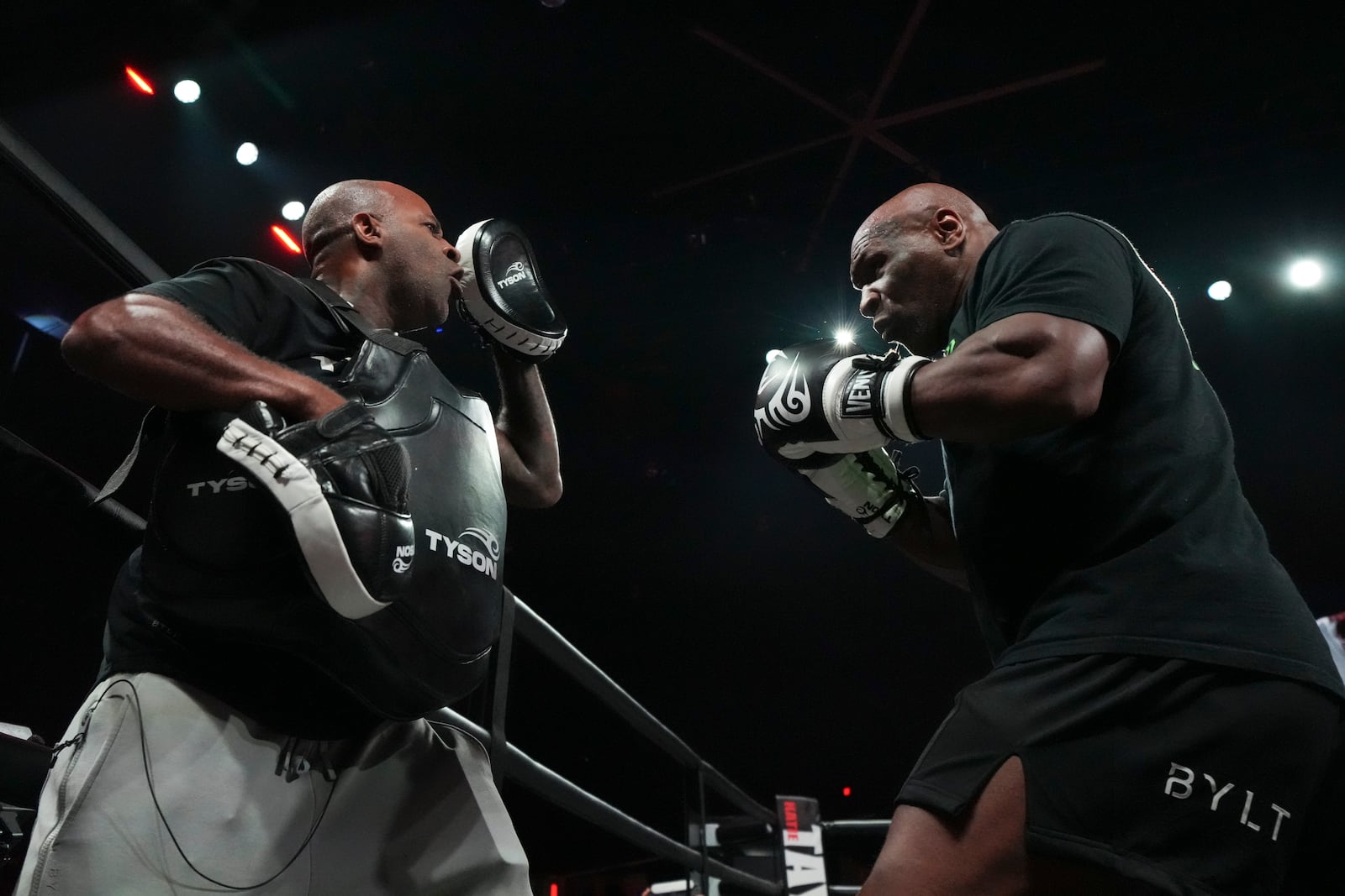 Mike Tyson, right, works out ahead of his boxing match against Jake Paul, Tuesday, Nov. 12, 2024, in Irving, Texas. (AP Photo/Julio Cortez)