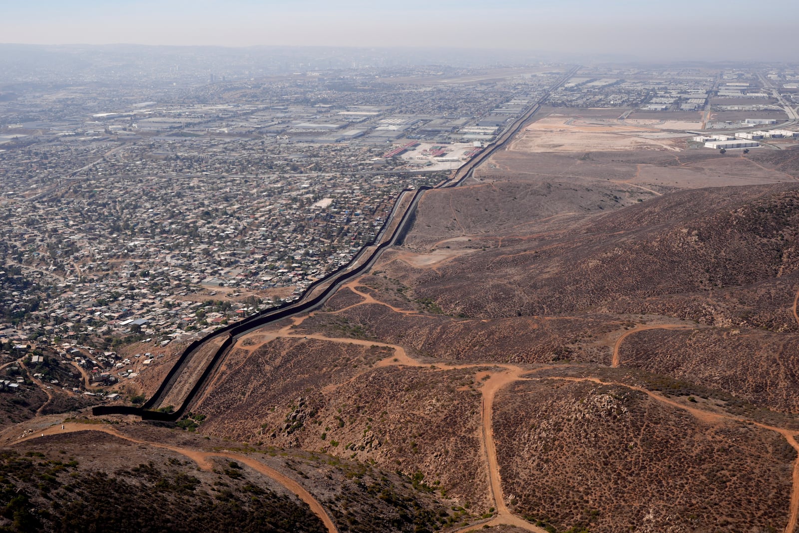 The U.S. Border with Mexico is seen in an aerial view Friday, Jan. 31, 2025, near San Diego. (AP Photo/Jae C. Hong)