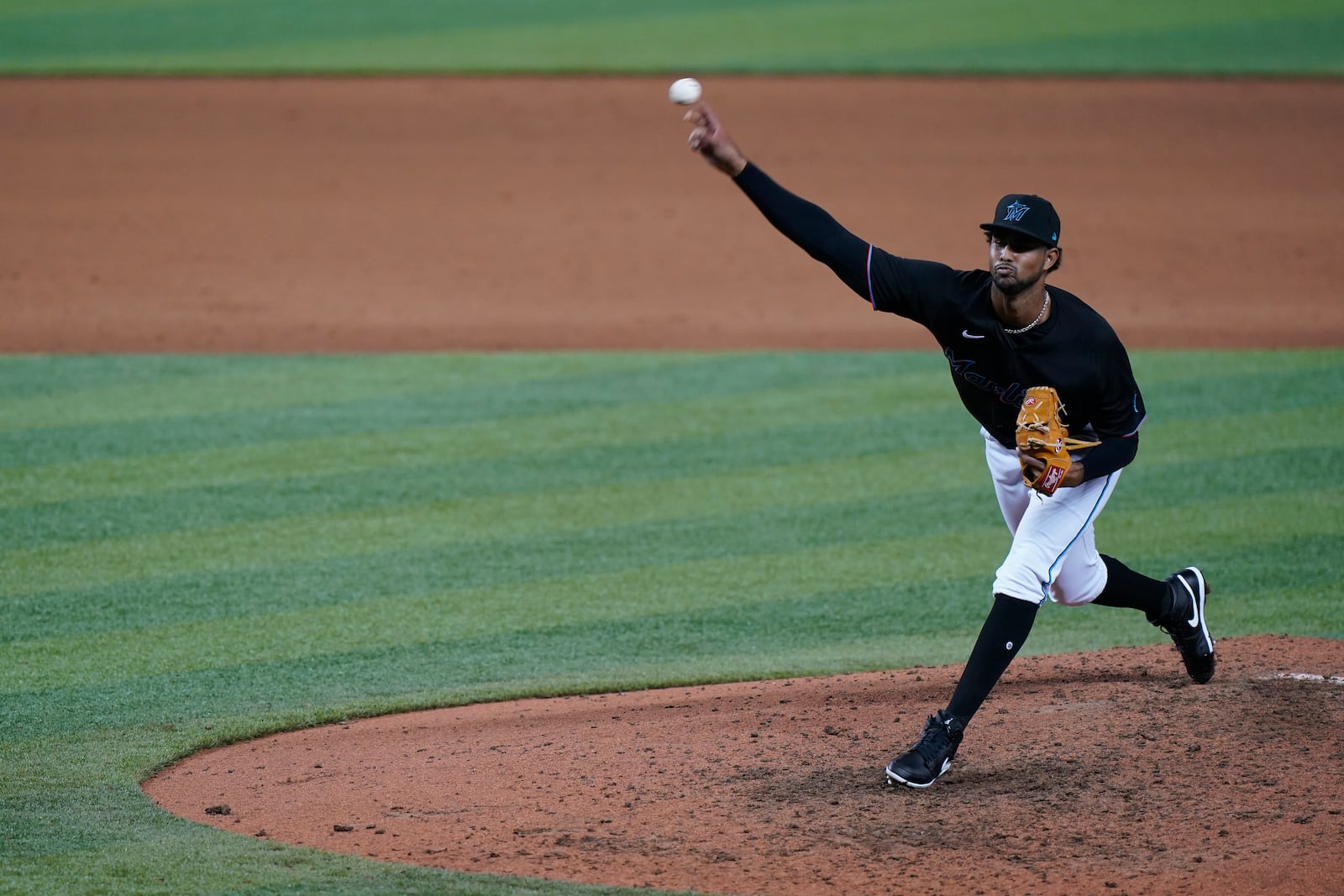 FILE - Miami Marlins' Johan Quezada pitches during a baseball game against the Philadelphia Phillies, in Miami, Sept. 12, 2020. Like other Dominican baseball players, Quezada felt pressure to perform while young: "We have to have baseball for breakfast, lunch and dinner if we want to get anywhere." (AP Photo/Wilfredo Lee, File)