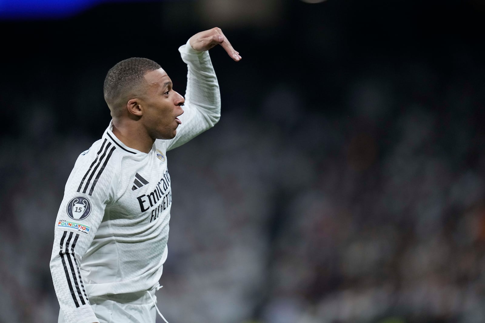 Real Madrid's Kylian Mbappe celebrates after scoring the opening goal of his team during the Champions League playoff second leg soccer match between Real Madrid and Manchester City at the Santiago Bernabeu Stadium in Madrid, Spain, Wednesday, Feb. 19, 2025. (AP Photo/Bernat Armangue)