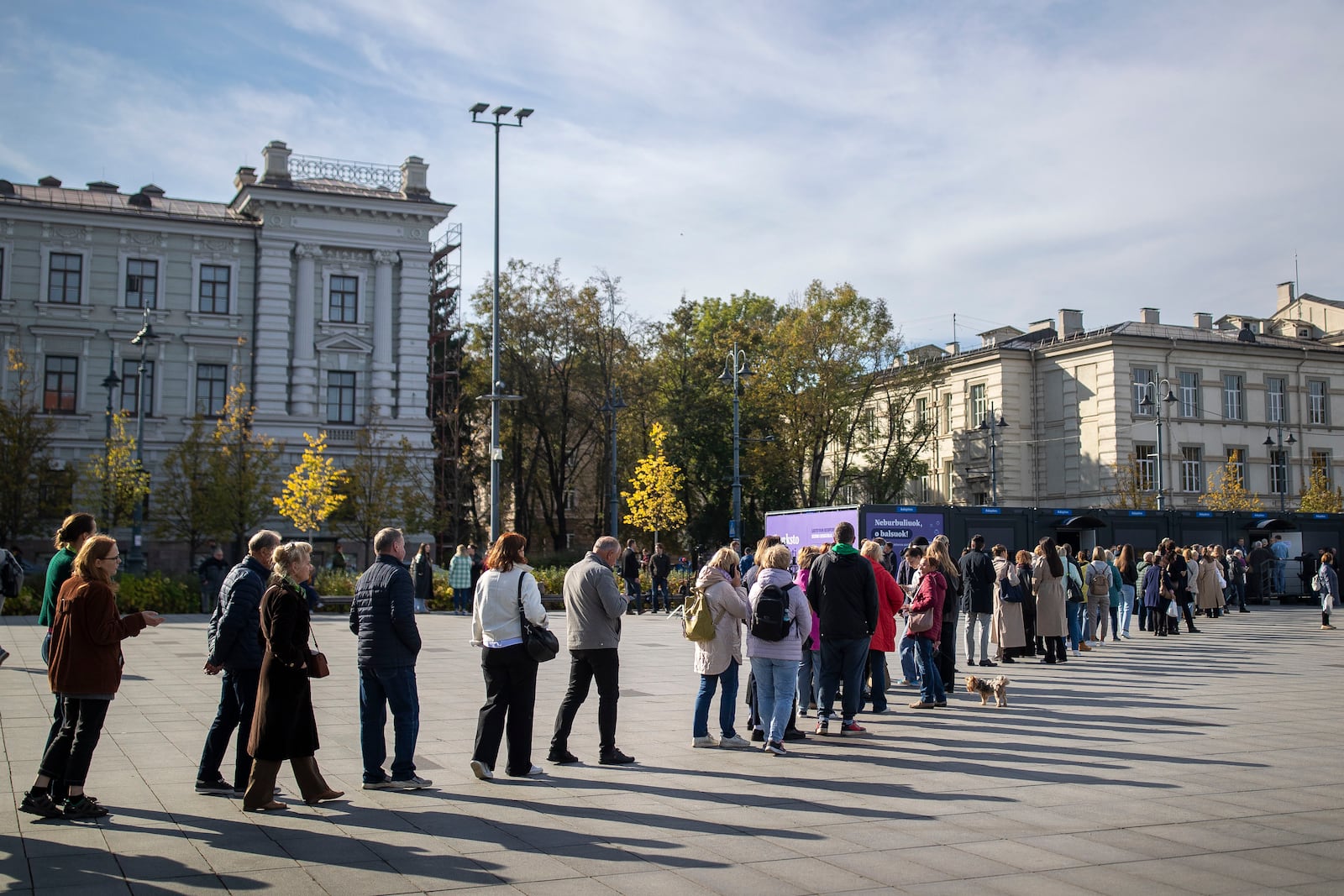 Voters queue at the polling station during the advance voting in the first round of a parliamentary election in Vilnius, Lithuania, Wednesday, Oct. 9, 2024. (AP Photo/Mindaugas Kulbis)