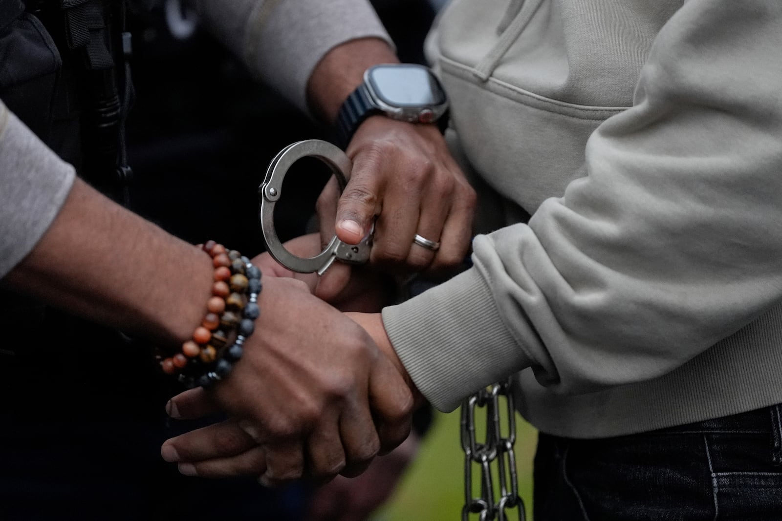 FILE - A U.S. deportation officer changes the handcuffs of Wilmer Patricio Medina-Medina from back to front after arresting him during an early morning operation, Dec. 17, 2024, in the Bronx borough of New York. (AP Photo/Julia Demaree Nikhinson, File)