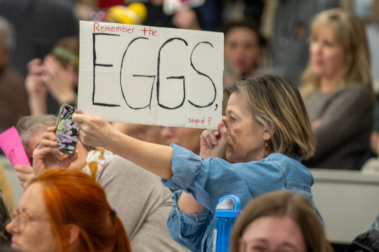 A participant holds a sign during a GOP town hall meeting with Reps. Celeste Maloy and Mike Kennedy, R-Utah, Thursday, March 20, 2025, in Salt Lake City. (AP Photo/Rick Egan)