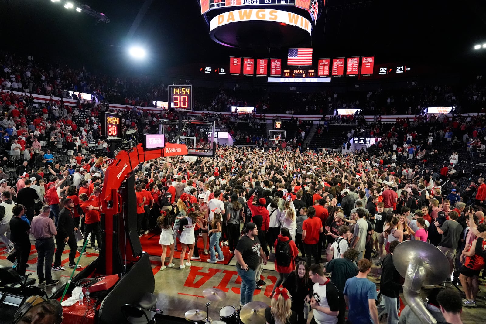 Georgia fans rush the court in celebration after an NCAA college basketball game against Florida, Tuesday, Feb. 25, 2025, in Athens, Ga. (AP Photo/Brynn Anderson)