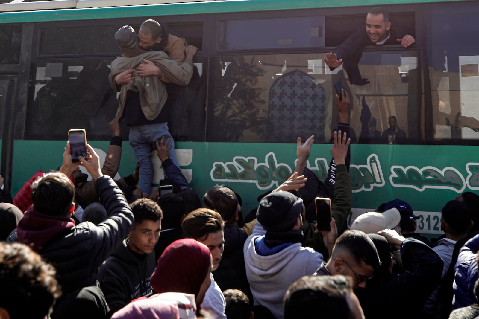 Freed Palestinian prisoners are greeted by relatives as they arrive in the Gaza Strip after being released from an Israeli prison following a ceasefire agreement between Hamas and Israel in Khan Younis, Gaza Strip, Saturday, Feb. 15, 2025. (AP Photo/Jehad Alshrafi)