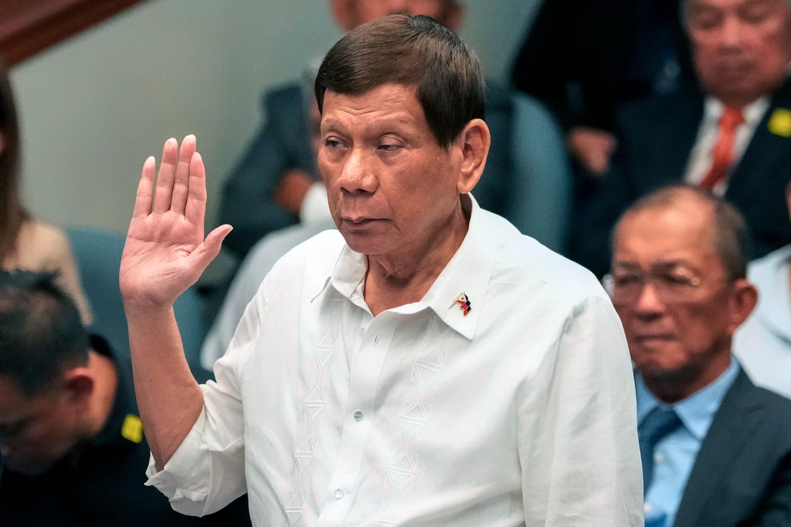 FILE - Former Philippine President Rodrigo Duterte takes oath during a senate inquiry on the so-called war on drugs during his administration at the Philippine Senate, on Oct. 28, 2024, in Manila, Philippines. (AP Photo/Aaron Favila,File)