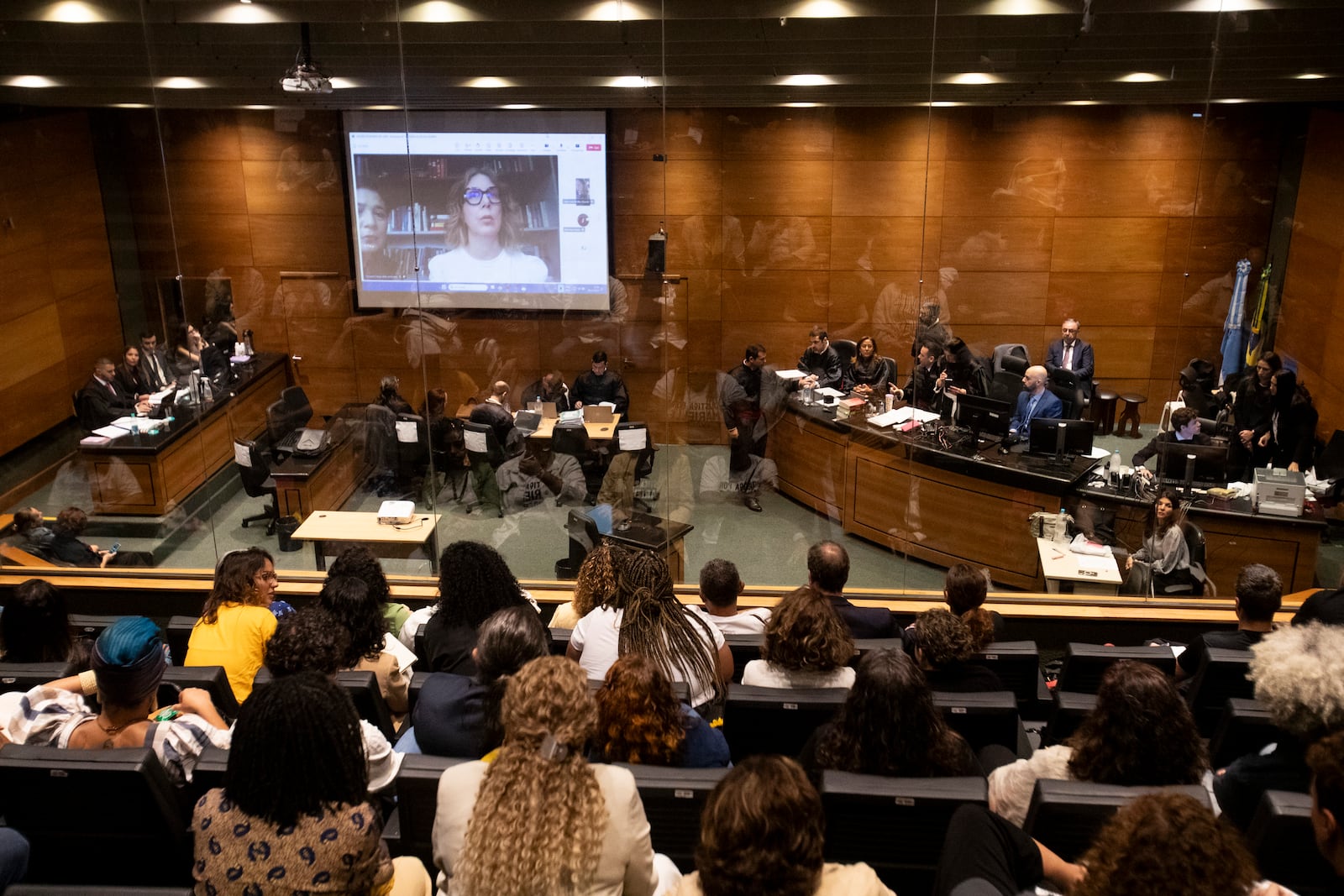 Advisor to slain city councilwoman Marielle Franco, Fernanda Goncalves Chaves, pictured on screen, testifies during the trial of Franco's suspected murderers, at the Court of Justice in Rio de Janeiro, Wednesday, Oct. 30, 2024. (AP Photo/Bruna Prado)