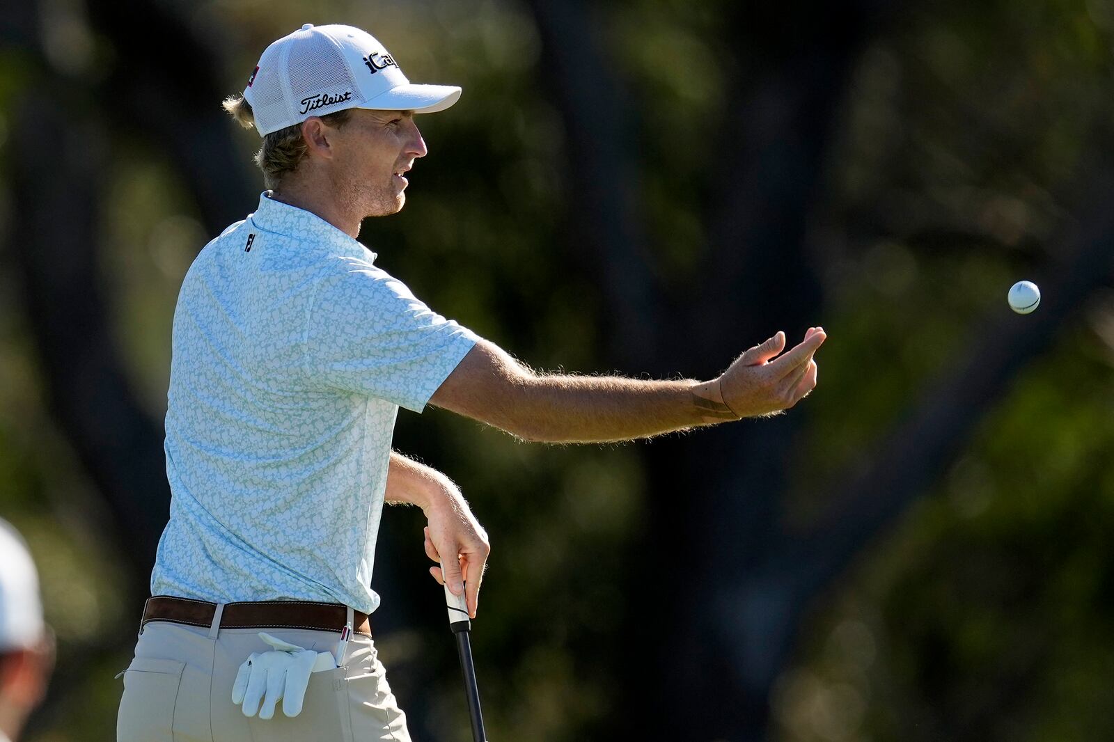 Will Zalatoris tosses his ball to his caddie on the fourth green during the first round of The Sentry golf event, Thursday, Jan. 2, 2025, at Kapalua Plantation Course in Kapalua, Hawaii. (AP Photo/Matt York)