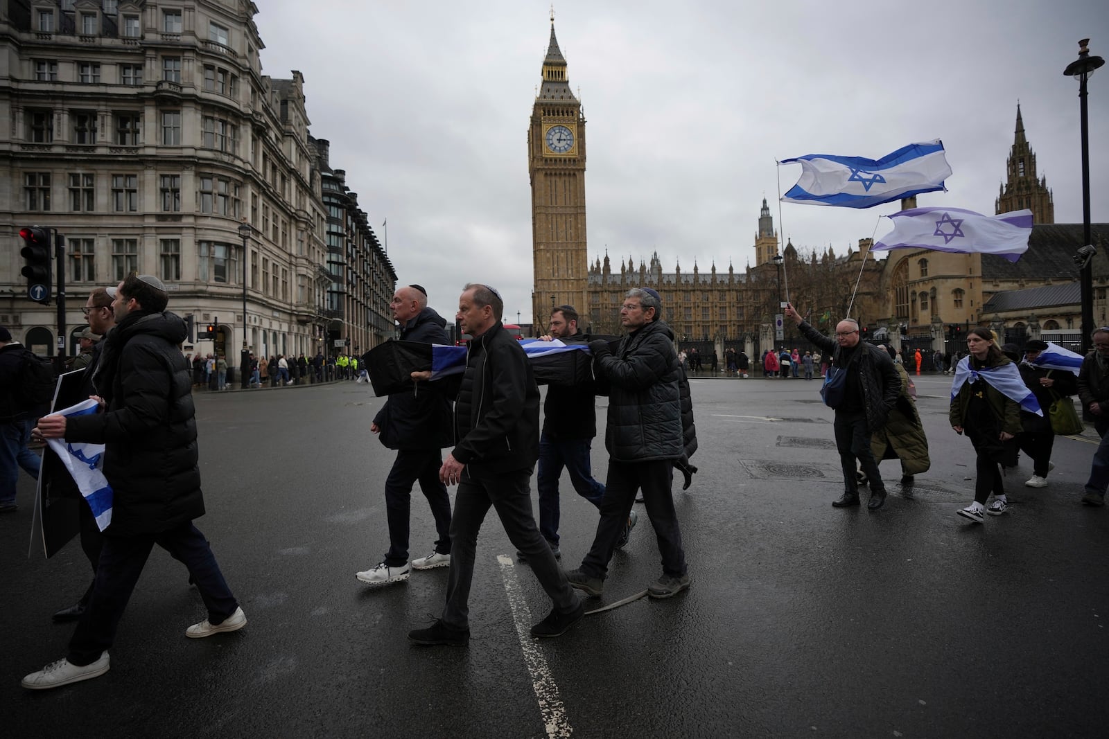 Mock coffins are carried through Westminster in London, Thursday, Feb. 20, 2025 to mourn hostages who have died in Gaza and demand the release of the remaining captives. (AP Photo/Kin Cheung)