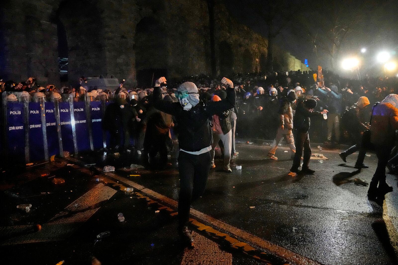 Police officers use pepper spray during clashes with people as they protest against the arrest of Istanbul's Mayor Ekrem Imamoglu, in Istanbul, Turkey, Friday, March 21, 2025. (AP Photo/Khalil Hamra)