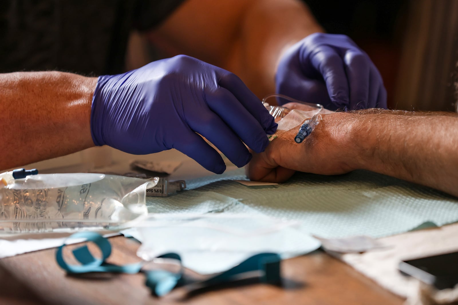 Jake Heinrichs prepares for his infusion treatment with an experimental anti-amyloid Alzheimer's drug while at home in New York, on Wednesday, March 12, 2025. (AP Photo/Heather Khalifa)