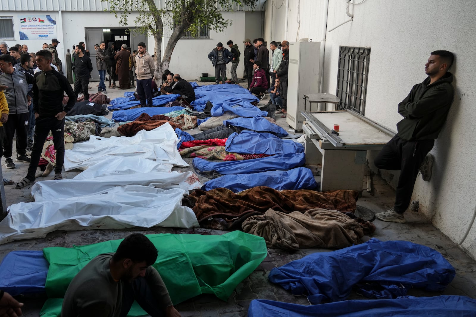 The bodies of Palestinians killed in an Israeli army airstrikes are brought to Shifa hospital in Gaza City, Tuesday, March 18, 2025. (AP Photo/Abdel Kareem Hana)