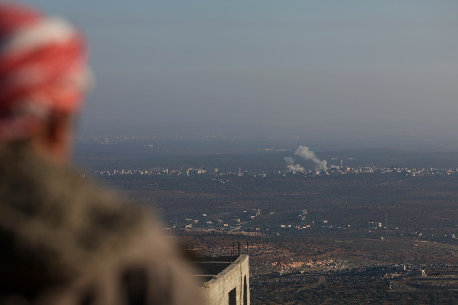 Smoke rises amid fighting between opposition factions and Syrian government troops in Majdaliya, Aleppo countryside, Syria, Thursday, Nov. 28, 2024. (AP Photo/Ghaith Alsayed)