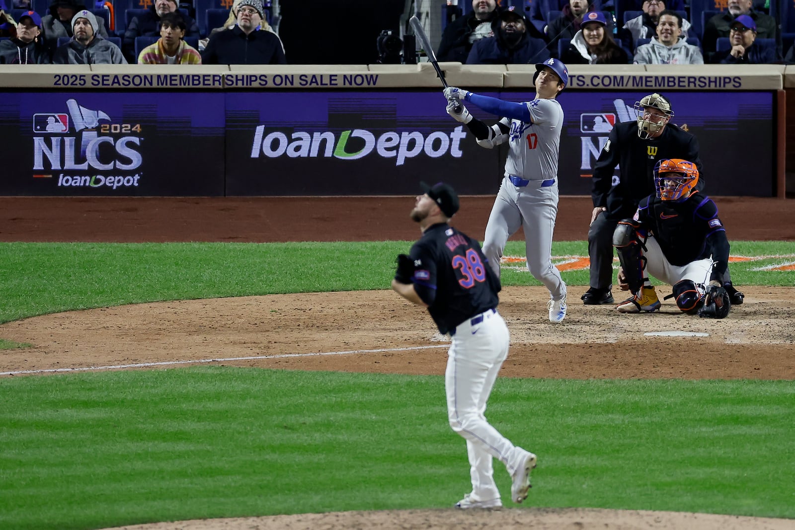 Los Angeles Dodgers' Shohei Ohtani watches his three-run home run against the New York Mets during the eighth inning in Game 3 of a baseball NL Championship Series, Wednesday, Oct. 16, 2024, in New York. (AP Photo/Adam Hunger)