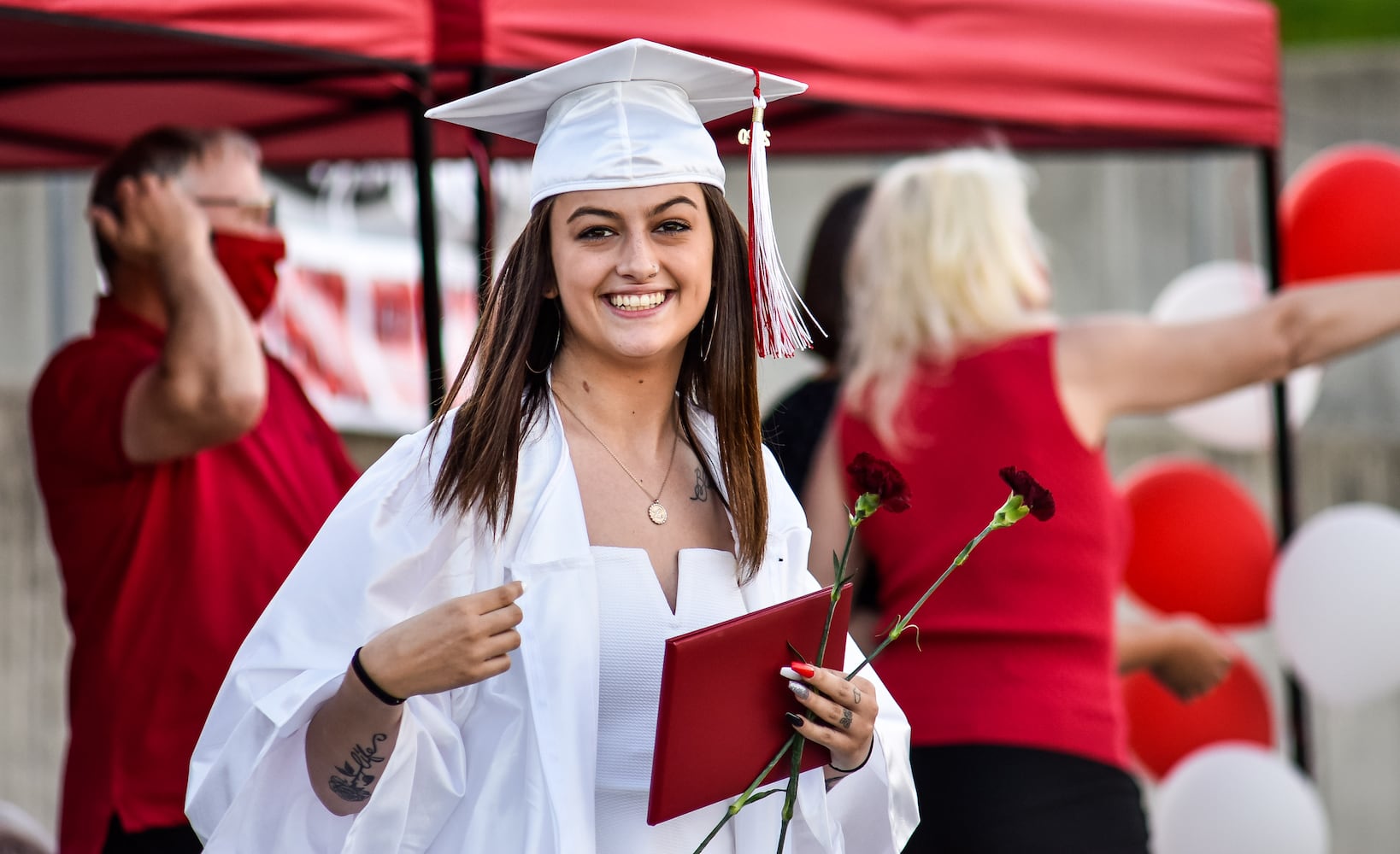 Madison High School drive-thru graduation ceremony at Land of Illusion