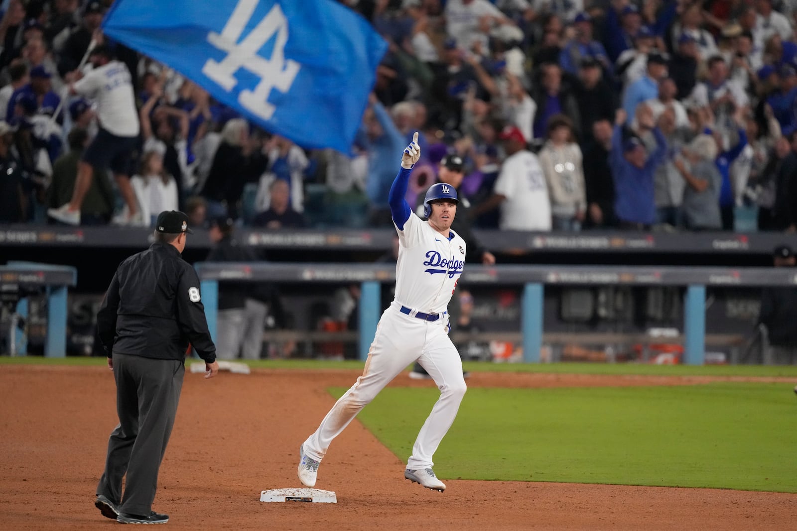 FILE - Los Angeles Dodgers' Freddie Freeman celebrates after hitting a walk-off grand slam home run during the 10th inning in Game 1 of the baseball World Series against the New York Yankees, Friday, Oct. 25, 2024, in Los Angeles. (AP Photo/Mark J. Terrill, File)