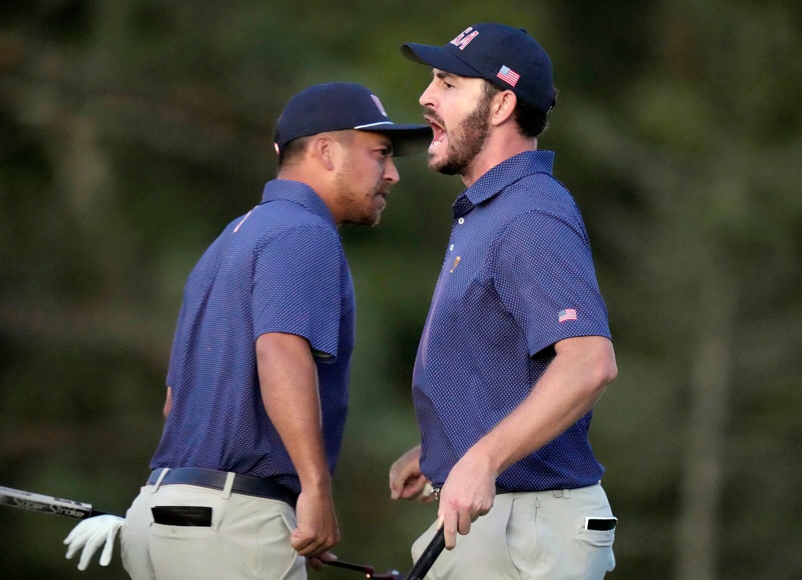 United States team member Patrick Cantlay, right, celebrates with partner Xander Schauffele, left, after winning their fourth-round foursomes match at the Presidents Cup golf tournament at Royal Montreal Golf Club in Montreal, Saturday, Sept. 28, 2024. (Frank Gunn/The Canadian Press via AP)