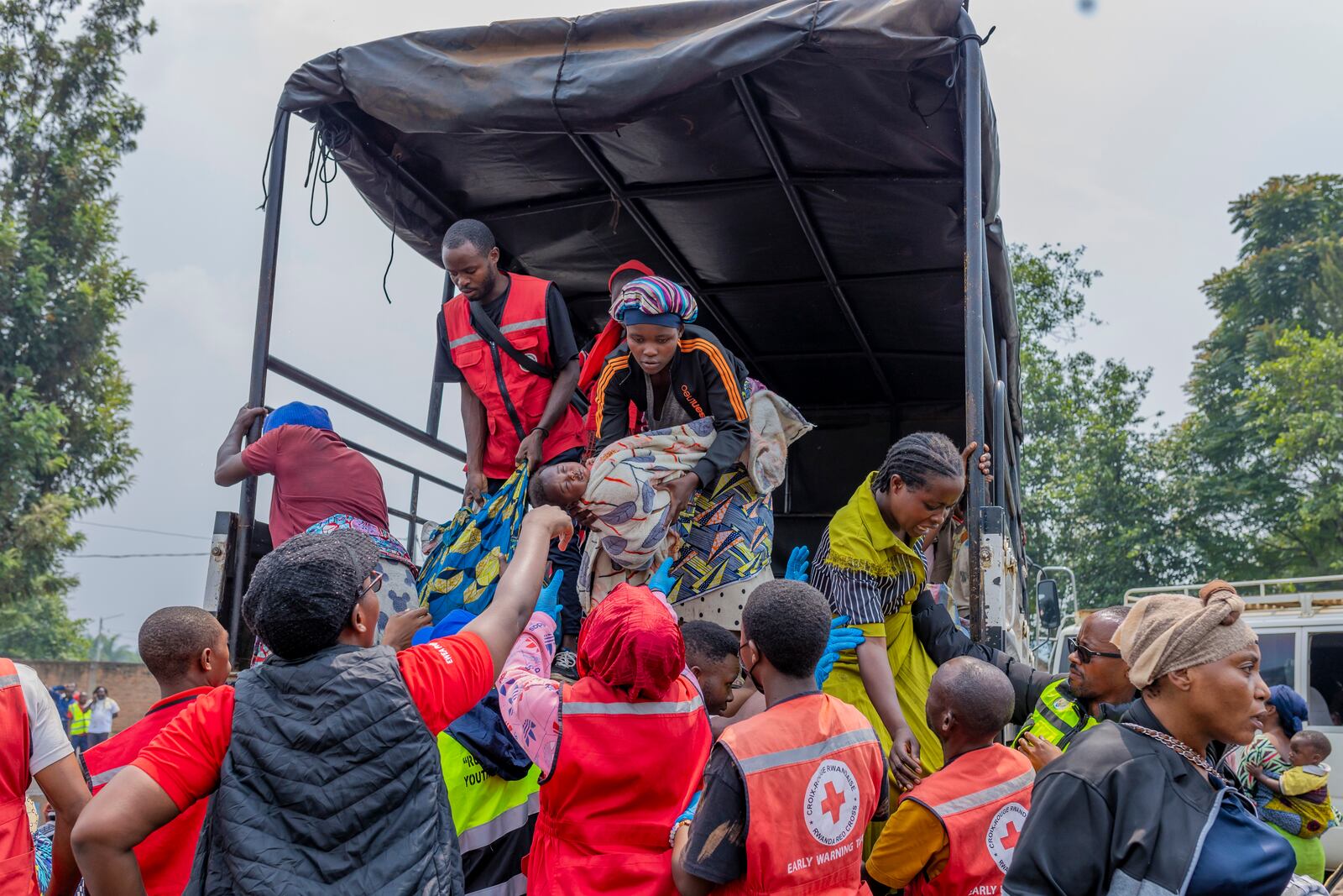 People who crossed from Congo disembark a truck in Gyseny, Rwanda, Tuesday, Jan. 28, 2025, following M23 rebels' advances into eastern Congo's capital Goma. (AP Photo/Yuhi Irakiza)