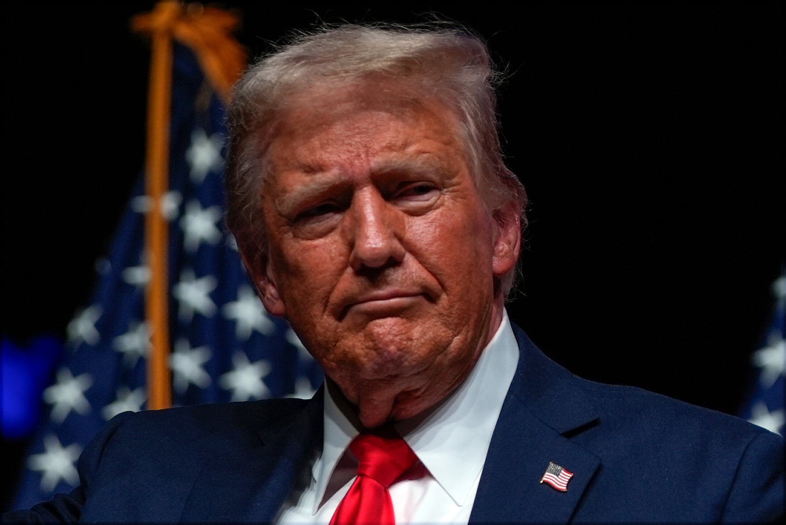 Republican presidential nominee former President Donald Trump listens during a Tucker Carlson Live Tour show at Desert Diamond Arena, Thursday, Oct. 31, 2024, in Glendale, Ariz. (AP Photo/Julia Demaree Nikhinson)