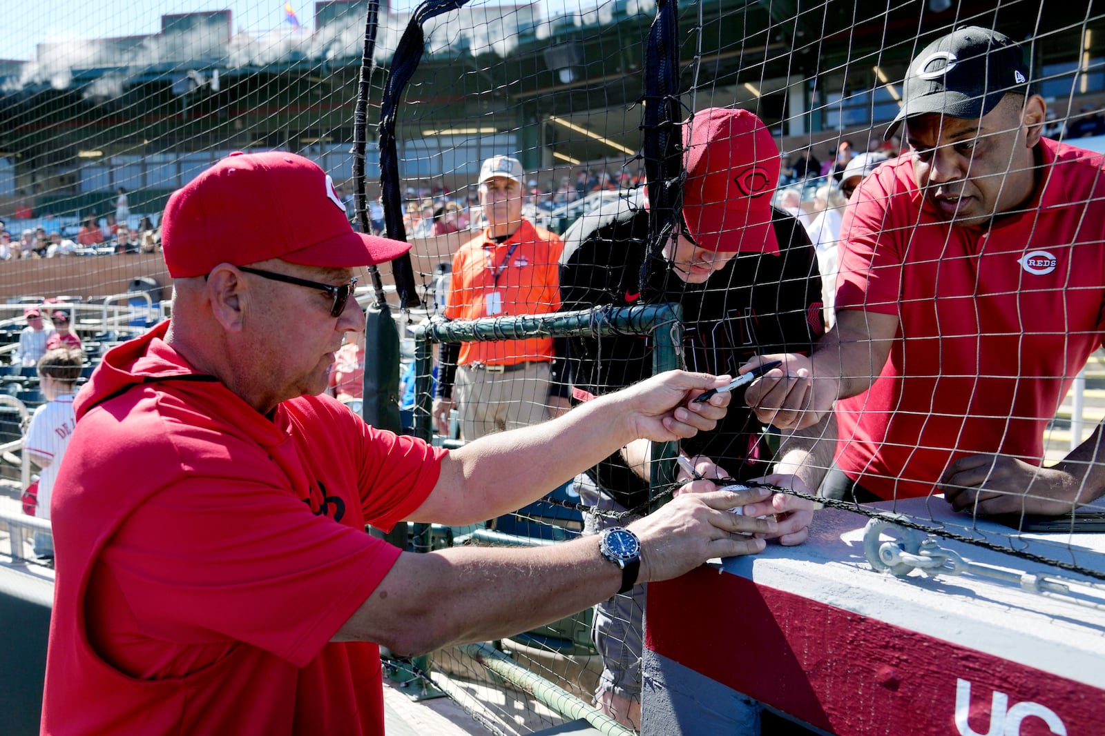 Cincinnati Reds manager Terry Francona signs autographs prior to a spring training baseball game against the San Francisco Giants, Sunday, Feb. 23, 2025, in Scottsdale, Ariz. (AP Photo/Ross D. Franklin)