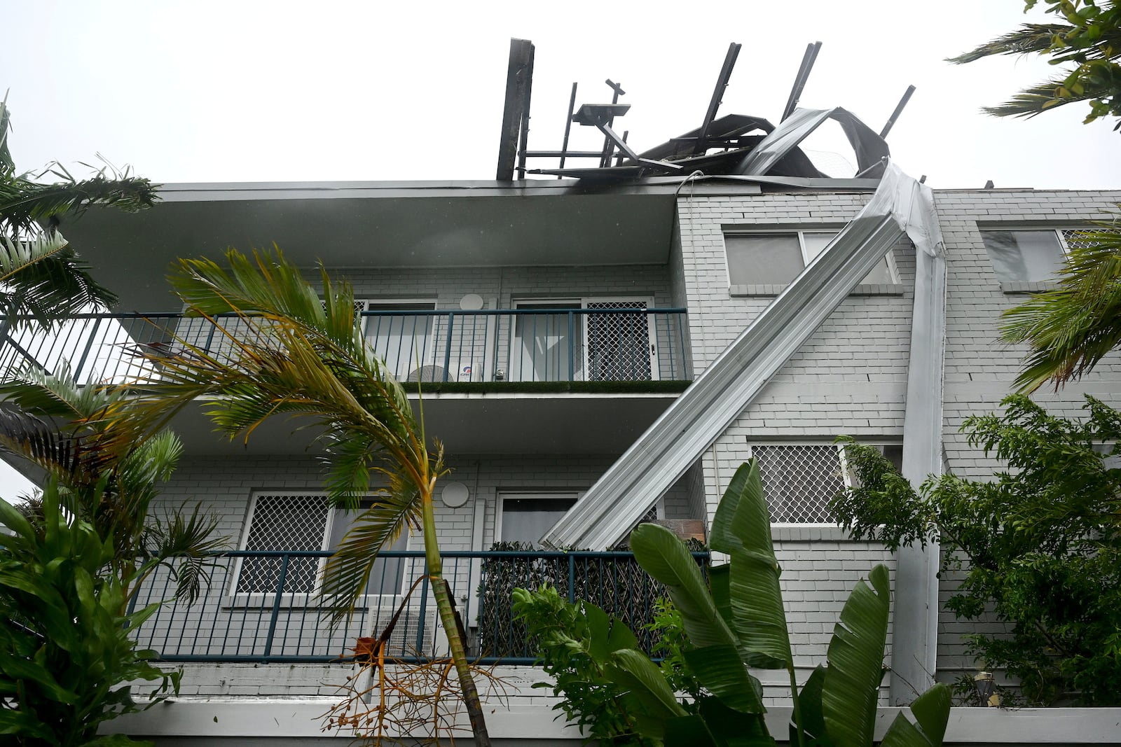 Damaged roofing on holiday apartments is seen at Labrador on the Gold Coast, Australia following Cyclone Alfred, Saturday, March 8, 2025. (Dave Hunt/AAP Image via AP)