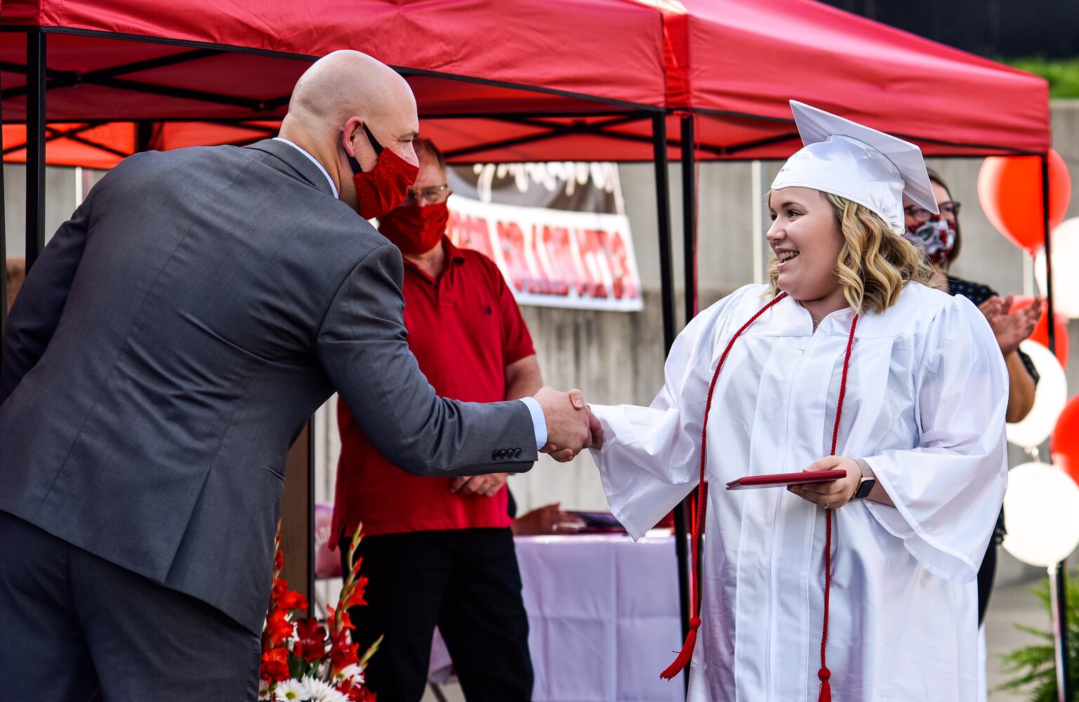 Madison High School drive-thru graduation ceremony at Land of Illusion