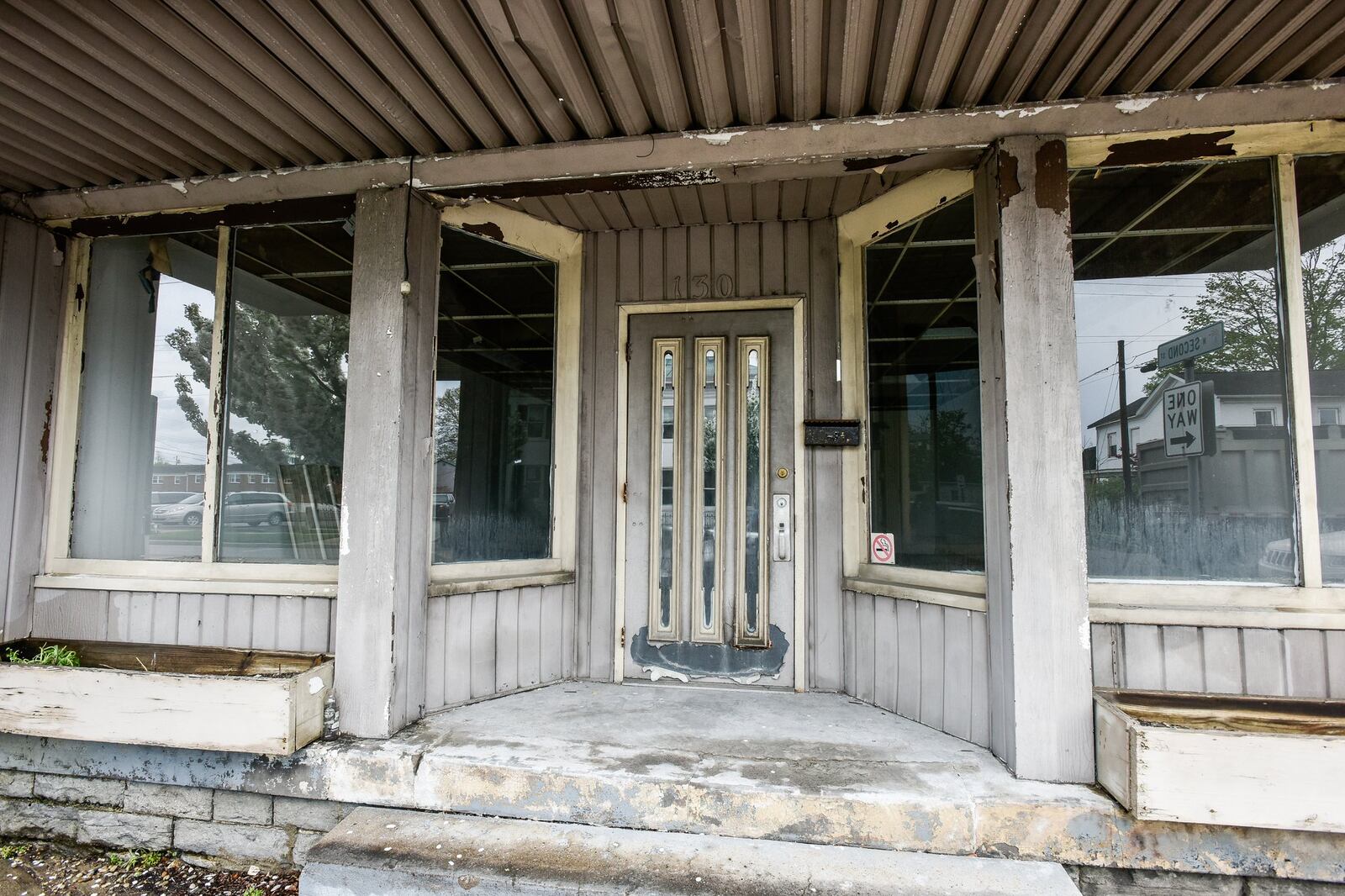 The Butler County land bank has approved razing a structure in downtown Trenton at a cost of $63,700 and demolition of the old Taylor School in Hamilton is on hold while a citizen’s group tries to save it. This property is located in the 100 block of E. State Street in Trenton. NICK GRAHAM/STAFF