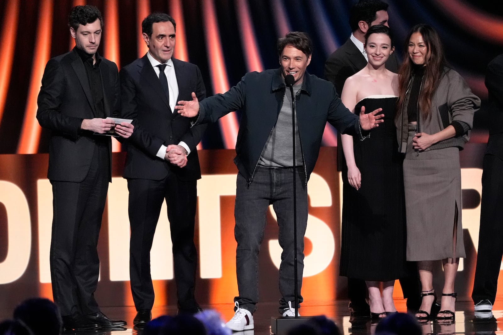 Sean Baker, center, accepts the award for best feature for "Anora" during the Film Independent Spirit Awards on Saturday, Feb. 22, 2025, in Santa Monica, Calif. Appearing with him are from left, Alex Coco, Karren Karagulian, Vache Tovmasyan, Mikey Madison, and Samantha Quan. (AP Photo/Chris Pizzello)